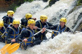 A group of friends is caught in rapids while Rafting on Le Chalaux River - Classic with AN Rafting Morvan.