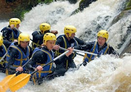 A group of friends is caught in rapids while Rafting on Le Chalaux River - Classic with AN Rafting Morvan.