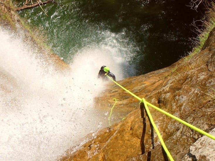 A participant in the Canyoning in the Torrente Vione organised by Skyclimber is facing the 45-metre-high abseil.