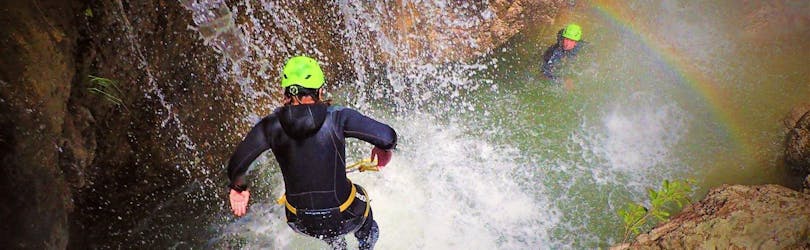 A participant of the Canyoning at Torrente Toscolano - Summerrain of Skyclimber is jumping into the water.