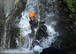 A girl is all smiles as she makes her way down the canyon during a canyoning trip in Alto Pirineo, organised by ROCROI.