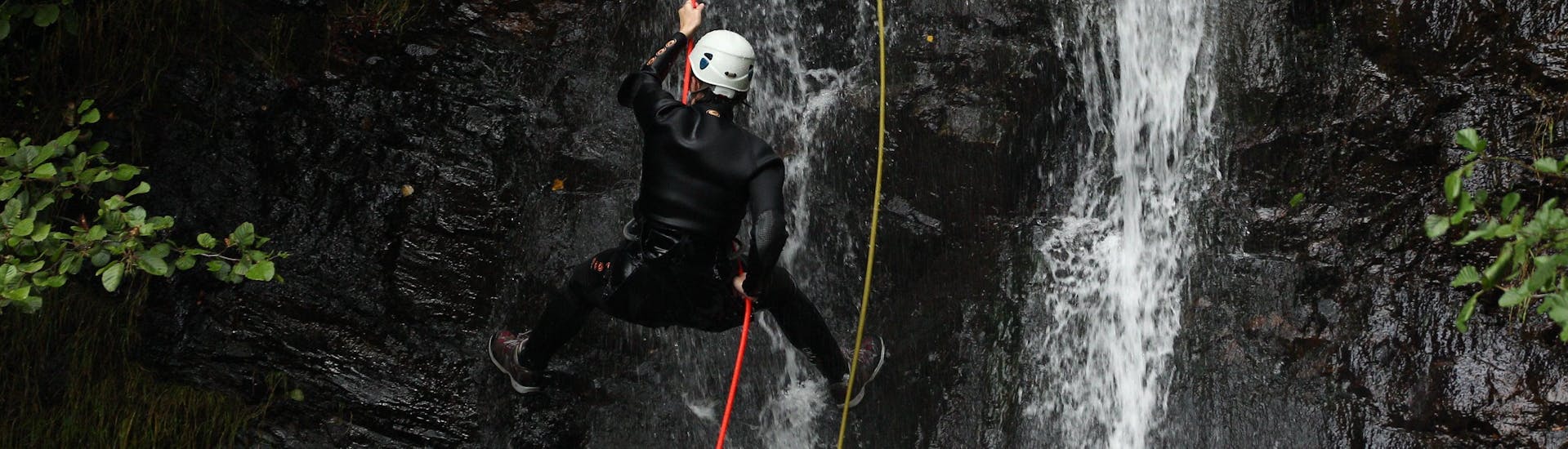 An abseiler is making his way down a cliff during a canyoning tour organised by ROCROI.