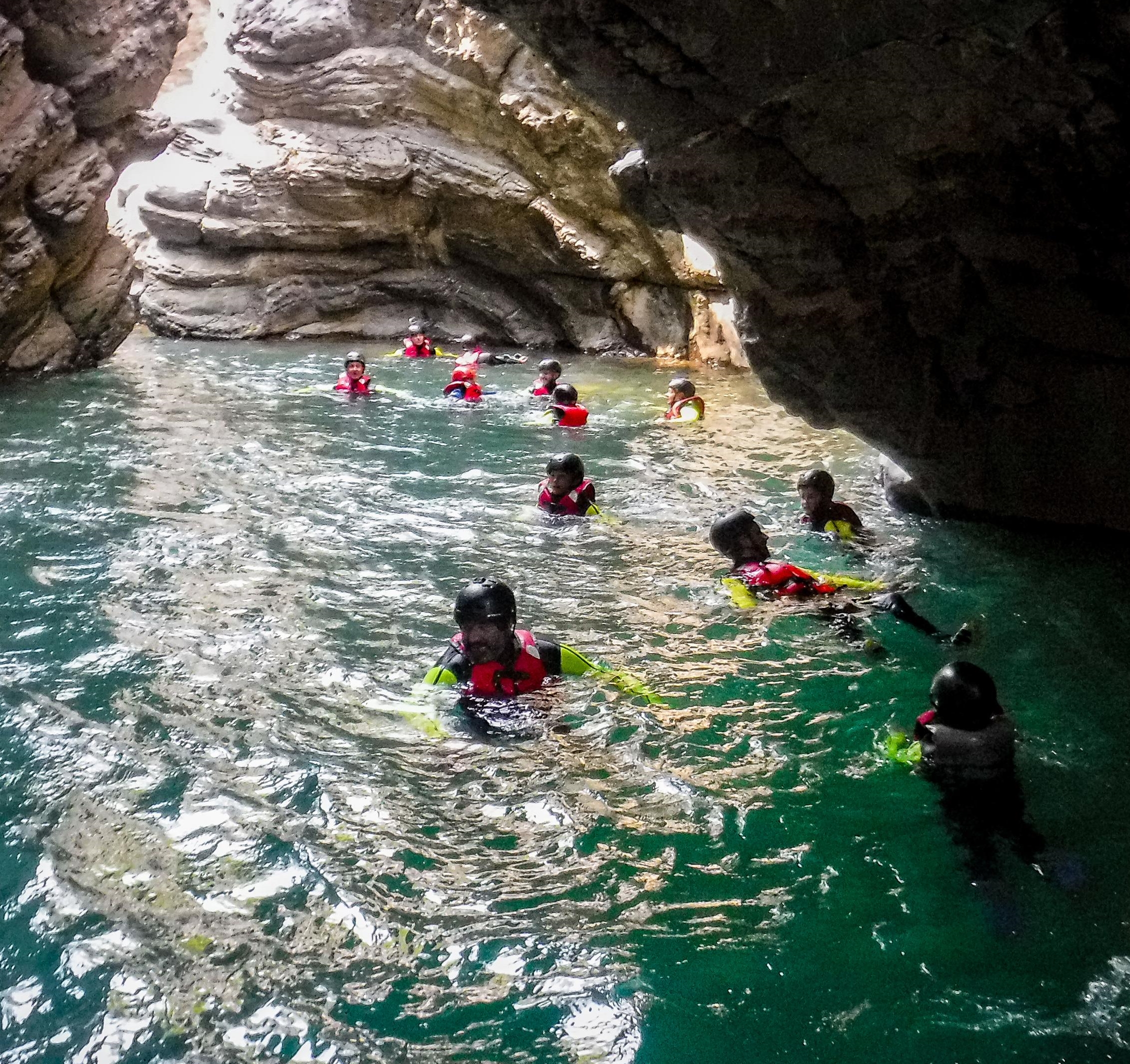 Participants swimming in the canyon during the Fun Riverplay in the Lima River with Garfagnana Rafting.