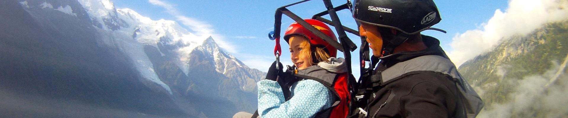 A child is enjoying their Tandem Paragliding Flight for Kids (4-12 years) with an experienced pilot from Kailash Paragliding.