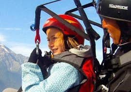 Baptême de parapente à Chamonix pour Enfants (4-12 ans) avec Kailash Parapente Chamonix Un enfant profite de son Vol Parapente Biplace pour Enfants (4-12 ans) en compagnie d'un pilote expérimenté de Kailash Parapente.