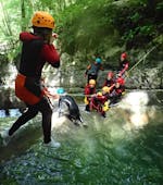 A woman participating to Canyoning "Discovery" - Canyon de Ternèze tour with Térreo Canyoning in jumping in the water.