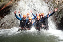 A group of friends participating to Canyoning "Sensation" - Canyon de Montmin with Térreo Canyoning are enjoying the waterfall.