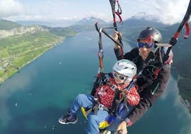 A child tries their first Tandem Paragliding at Lake Annecy for Kids (5-14 y.) with Takamaka Annecy.