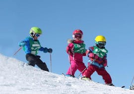Young skiers skate down a slope during a kids ski lesson with the ESF Les Orres. 