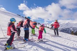 Le moniteur de ski de l'école de ski Sertorelli Bormio discute avec les enfants du Cours de ski Enfants (4-12 ans) avec Expérience - Demi-journée.