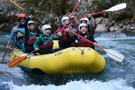 A group happily lifts their paddles during the Rafting Family on the Noguera Pallaresa with La Rafting Company.