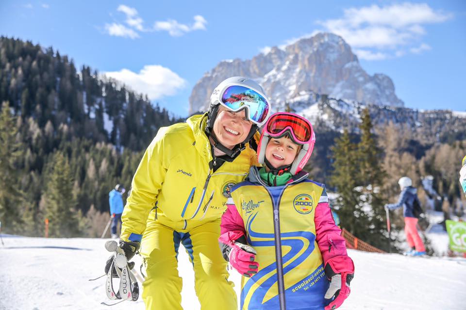 Ski instructor and kid in Selva di Val Gardena (Wolkenstein) during one of the Private Ski Lessons for Kids of All Levels.