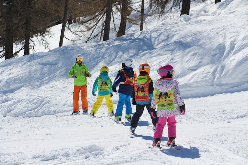Ski instructors and kids on the slopes of Folgarida during one of the kids ski lessons for all levels full day.