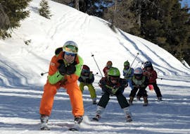 Ski instructor and kids racing during one of the kids ski lessons for all levels half day in Folgarida.