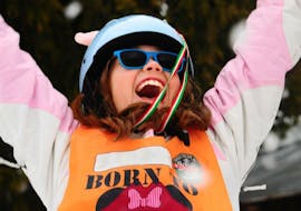 Kids Ski Lessons "Half Day" (3-4 years) - Beginner Ski School AEvolution Folgarida are at the end, a little girl has been awarded and celebrates on the podium.