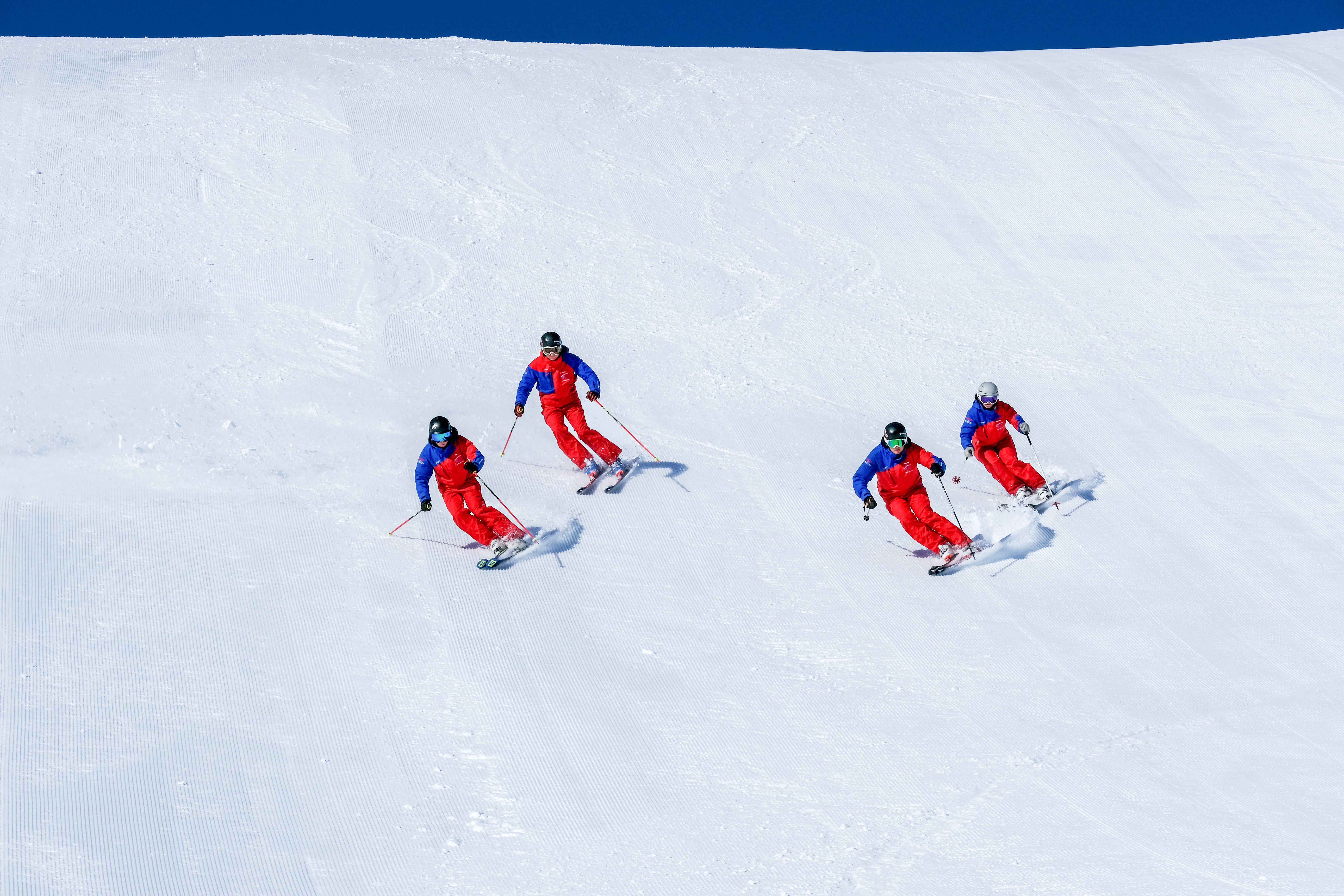 Teens listen to the ski instructor in the ski course for teens (14-17 years) - beginners.