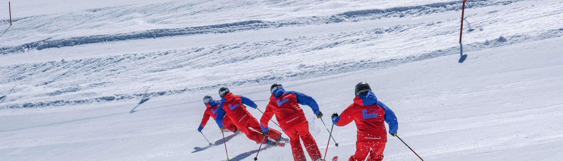 Les adolescents écoutant le moniteur de ski dans le cours de ski pour adolescents (14-17 ans) - débutants.