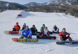 A Ski Connections instructor and his students take a well-deserved break during a snowboarding lesson for teens and adults in Serre-Chevalier. 