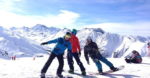 Snowboarding Lessons for Advanced Boarders - Half Day with the ski school Ischgl Schneesport Akademie Three boys take a break on the snow; snowboarding lessons for Kids & Adults - Half Day - Advanced of the ski school Skischule Ischgl Schneesport Akademie have made them happy.