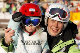 Child and ski instructor posing for a picture in Bormio during one of the Private Ski Lessons for Kids of All Levels & Ages.