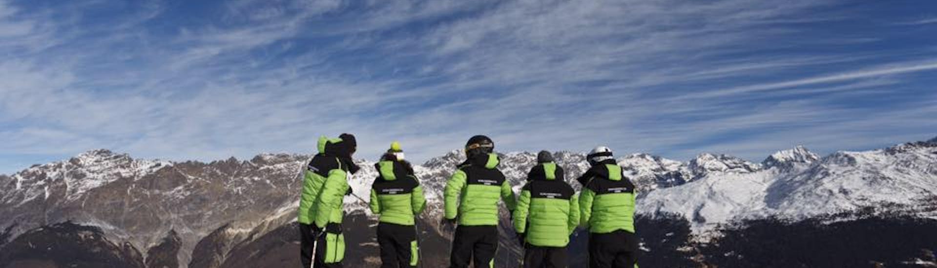 Ski instructors in front of the mountains in Bormio before one of the Private Ski Lessons for Kids of All Levels & Ages.