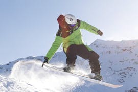 Snowboard instructor jumping in Bormio during one of the Private Snowboarding Lessons for Kids & Adults of All Levels.