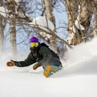 A snowboarder enjoying the private snow during his Private Snowboarding Lessons for Kids & Adults - All Levels from Out of Bounds Snowboard School .