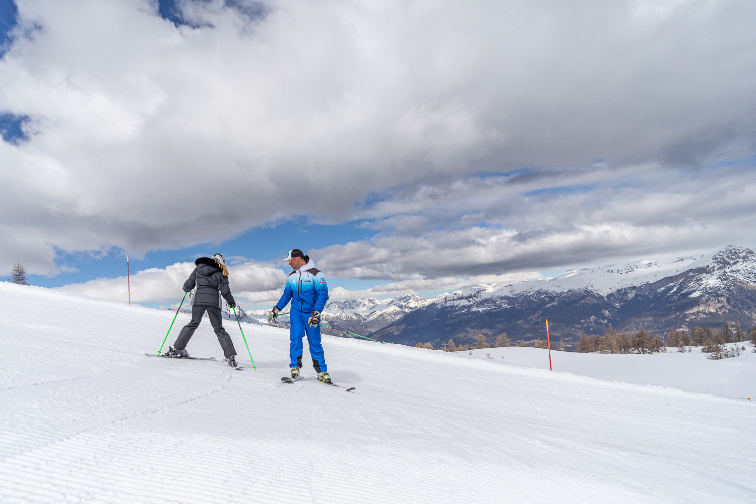 Ski instructors are training before one of the private ski lessons for adults of all levels in Sauze d'Oulx.