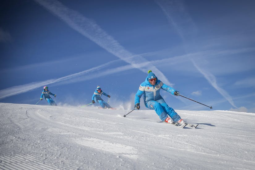 Ski instructors are training before one of the private ski lessons for adults of all levels in Sauze d'Oulx.