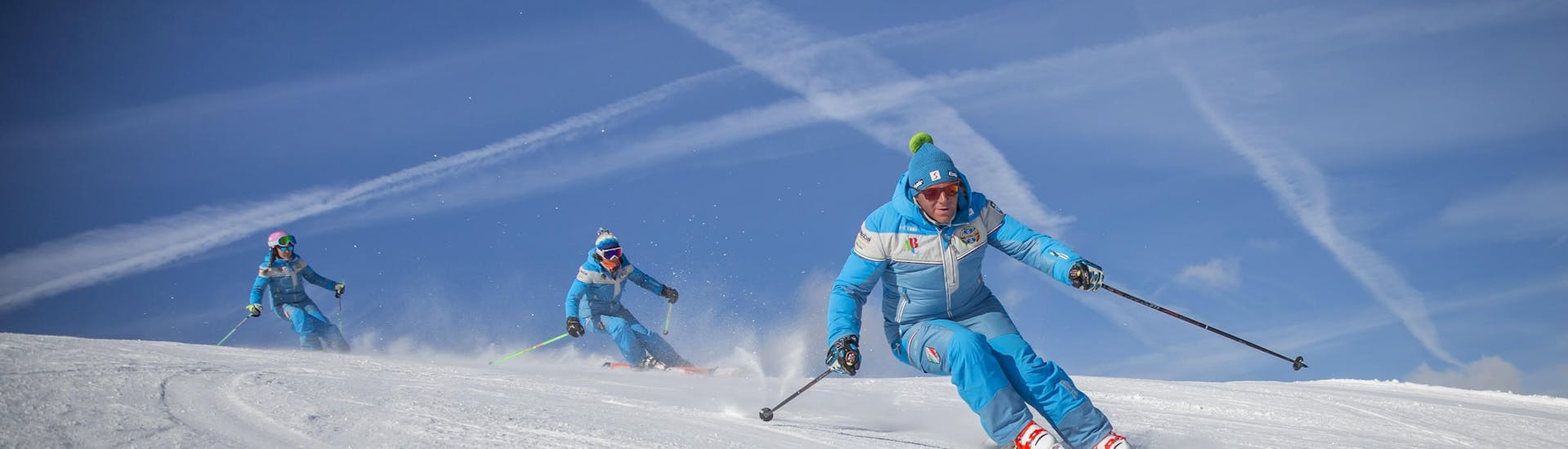 Ski instructors are training before one of the private ski lessons for adults of all levels in Sauze d'Oulx.