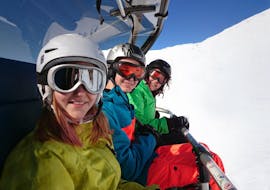A ski instructor from ESI Glycérine and his two students take the chairlift together during a private adult one-day ski course in Anzère.
