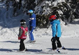 Ski instructor with kids on the slopes of Monte Elmo during one of the kids ski lessons for first timers.
