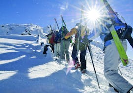People are following a ski touring guide of ski school Club Alpin in Grän.