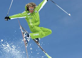 A skier is jumping during private ski lessons for adults with ski school Club Alpin in Grän.