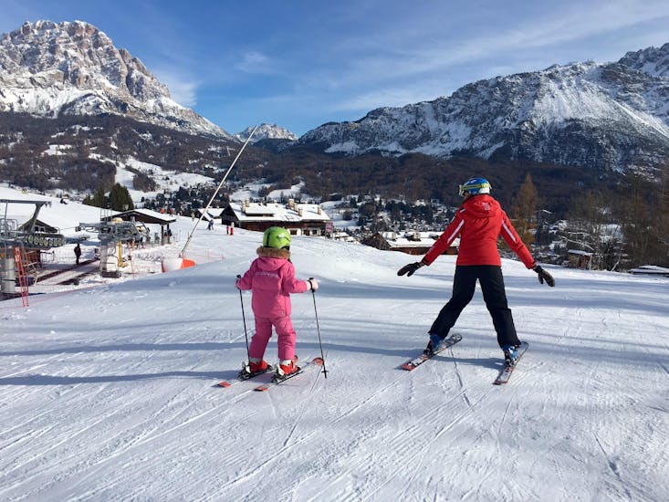 Kid and ski instructor in Cortina during on e of the Private Ski Lessons for Kids of All Levels.