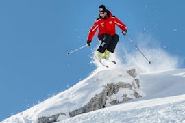 Un moniteur de ski de l'école de ski Scuola Sci Cortina montre comment skier hors-piste pendant les cours particuliers de ski freeride et télémark pour adultes.