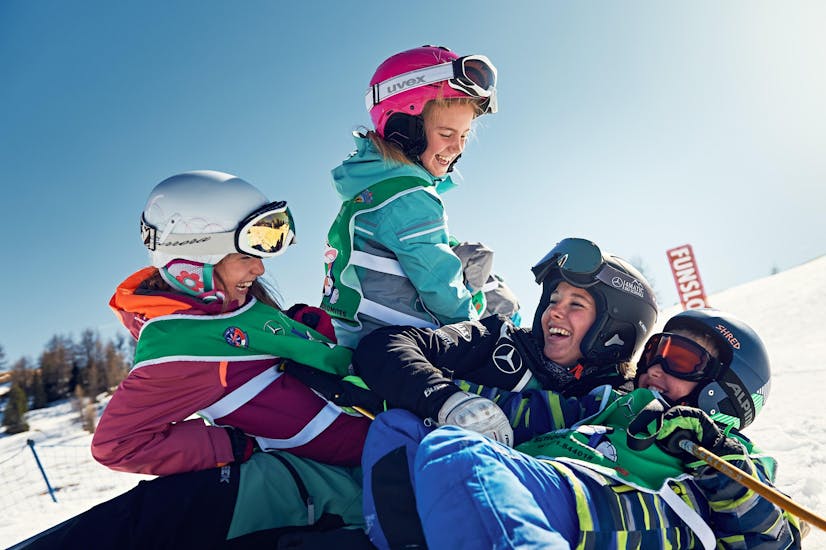 Bambini si divertono a La Villa durante una delle lezioni private di sci per bambini per tutti i livelli.