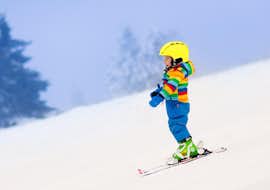 private-ski-lessons-for-kids-(3-16-y.)-of-all-levels-skischule-oetscher A small child going downhill during Private Ski Lessons for Kids (3-16 y.) of All Levels with Ski school Ötscher.