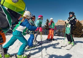 Kids and ski instructors in San Cassiano during one of the Kids Ski Lessons (4-12 y.) for All Levels.
