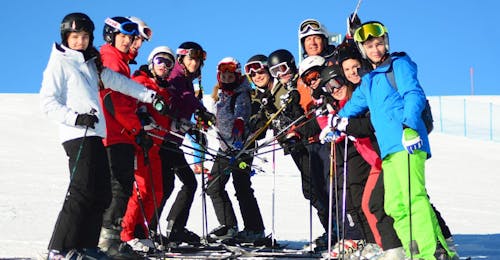 Adults Ski Lessons for All Levels from Scuola di Sci Equipe Falcade Participants taking a picture together in Falcade during one of the Adults Ski Lessons for All Levels.