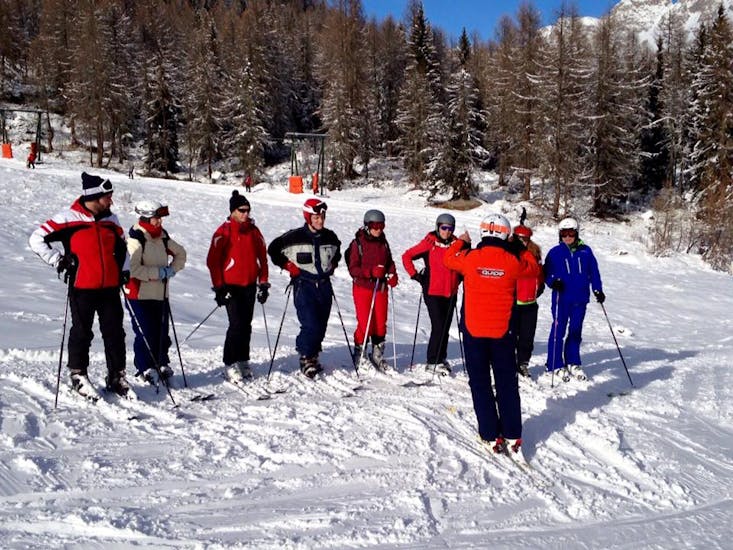 Adults with ski instructors in Falcade during one of the Adults Ski Lessons "Mini Groups" for All Levels.