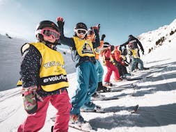 A kid is participating to Kids Ski Lessons (5-12 y.) - Arc 1950 with Evolution 2 Spirit - Arc 1950 & Villaroger.