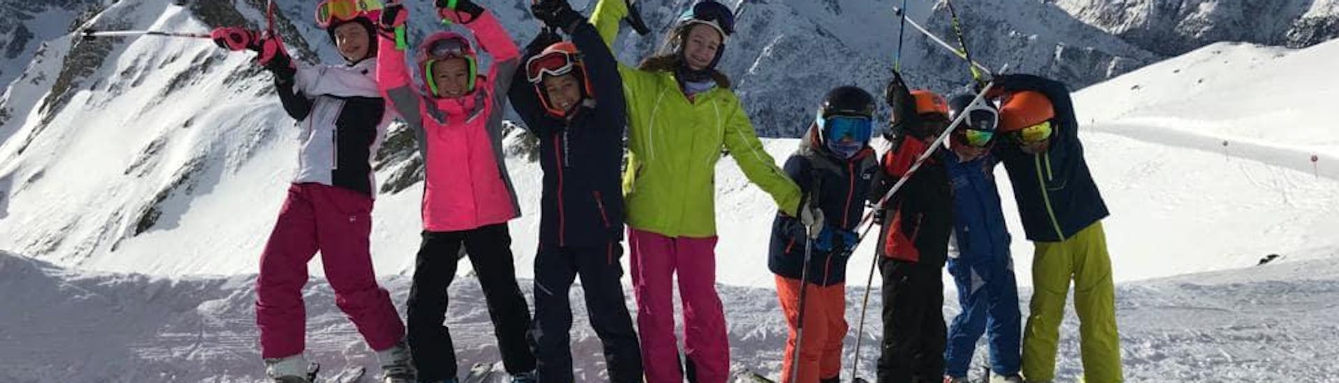 Happy participants in Pontedilegno during one of the kids ski lessons for beginners.