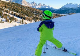 Kid enjoying the view of the mountains in Predazzo during one of the private ski lessons for kids of all levels.