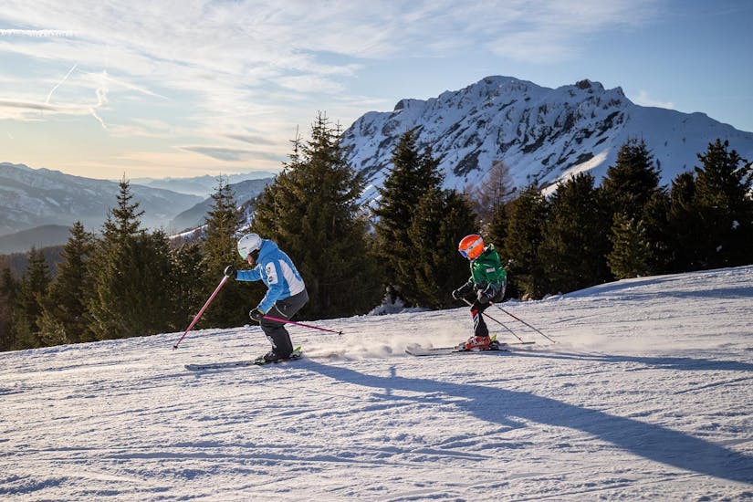 Kid and ski instructor during one of the private ski lessons for kids of all levels.