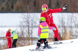 A kid is learning how to ski during their Private Ski Lessons for Kids (from 3 y.) of All Levels with Premiere Ski School Vysoké Tatry.