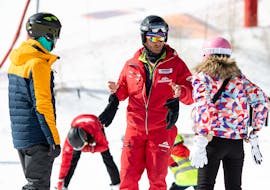 An instructor is giving advice to skiers during Private Ski Lessons for Adults of All Levels with Premiere Ski School Vysoké Tatry.