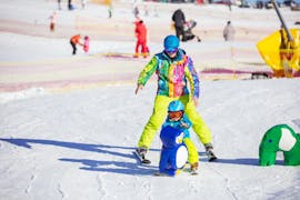A kid is taking Private Ski Lessons for Kids - High Season - Arc 1950 with Evolution 2 Spirit - Arc 1950 & Villaroger.