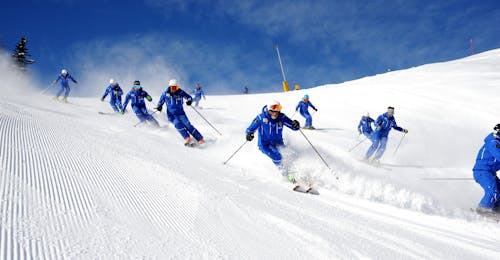 Adult Ski Lessons for All Levels with the Ski School Folgarida Dimaro Ski Lessons for Adults - All Levels of the Folgarida Dimaro Ski School are taking place, participants are training on the slopes of Val di Sole.