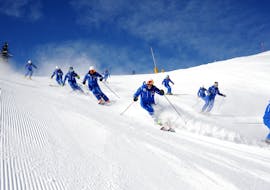 Ski Lessons for Adults - All Levels of the Folgarida Dimaro Ski School are taking place, participants are training on the slopes of Val di Sole.